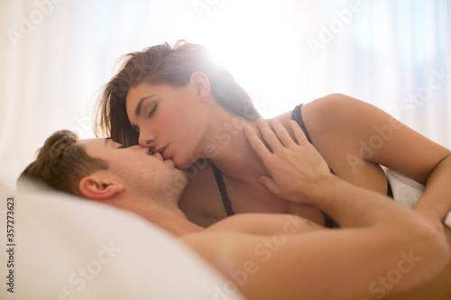 Couple kissing in bed