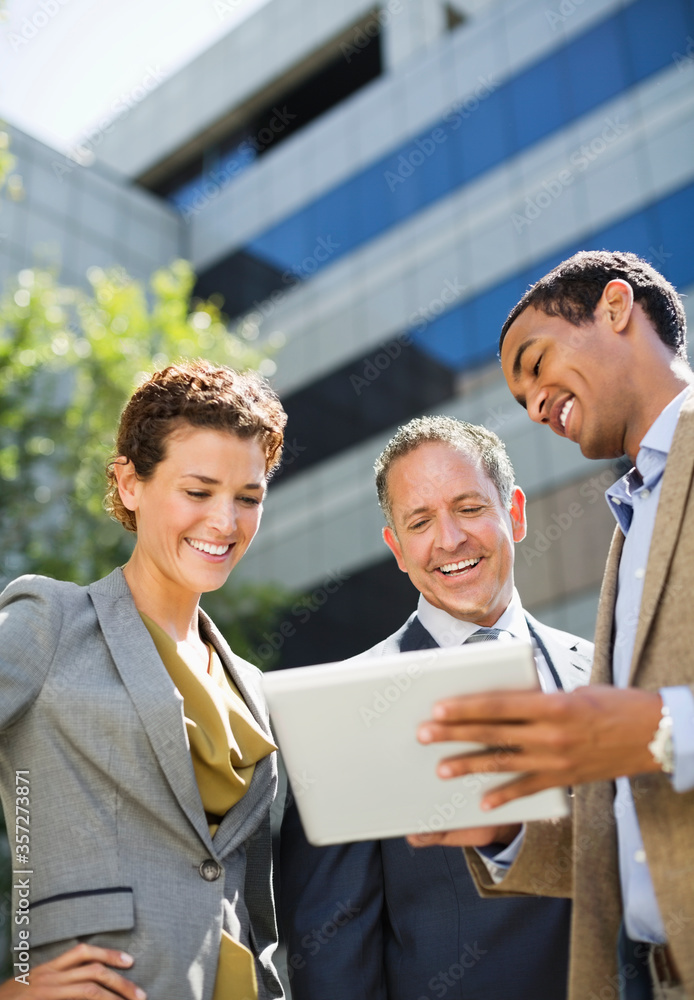 Fototapeta premium Business people using tablet computer outdoors