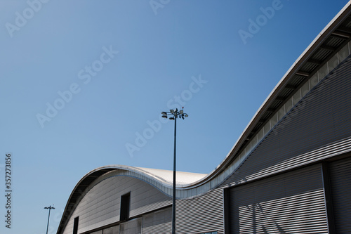 Curved roof of warehouse and blue sky