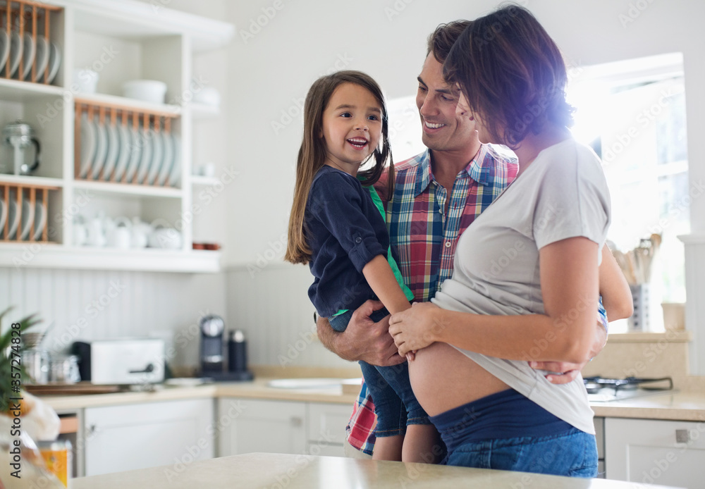 Girl touching pregnant mothers belly Girl touching pregnant mothers belly