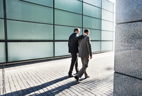 Businessmen talking on city street