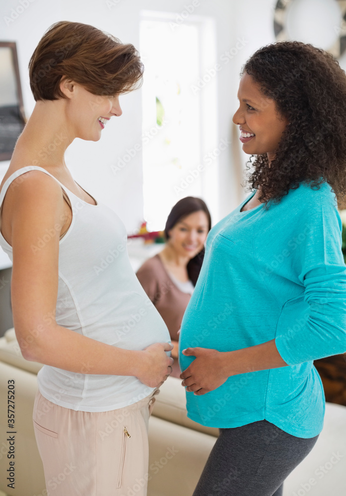 Pregnant women touching bellies Pregnant women touching bellies