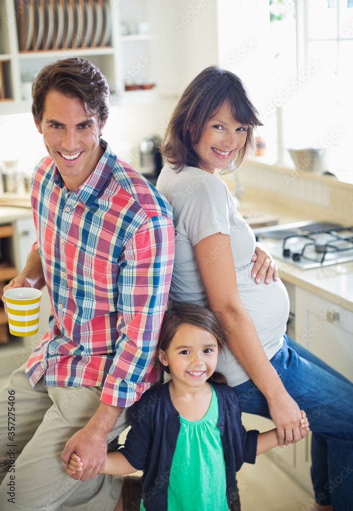 Family smiling together in kitchen Family smiling together in kitchen