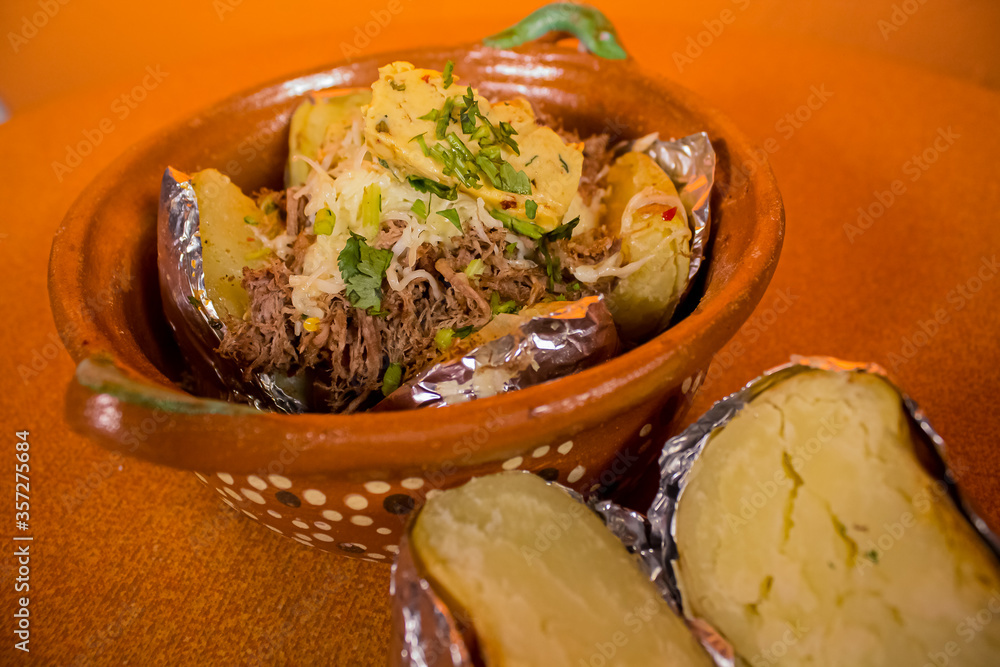 Papa asada con carne, queso y verduras