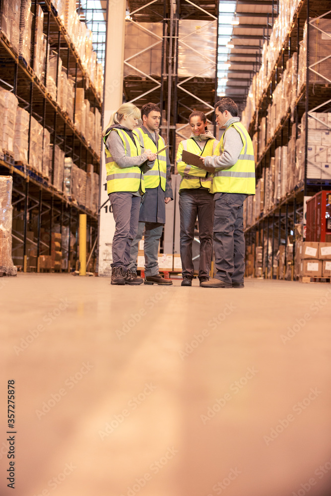 Workers talking in warehouse