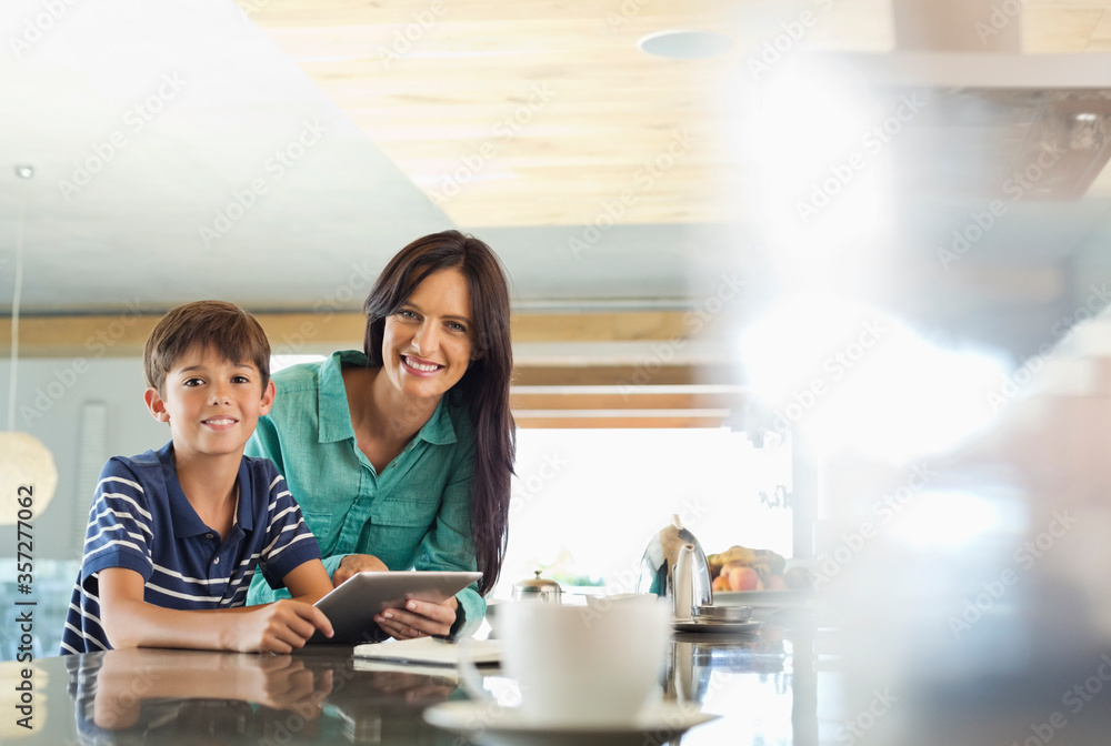 Mother and son using tablet computer in kitchen Mother and son using tablet computer in kitchen