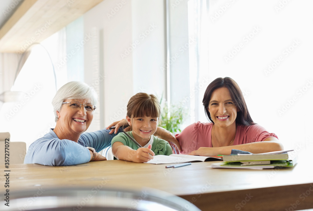 Three generations of women doing homework Three generations of women doing homework