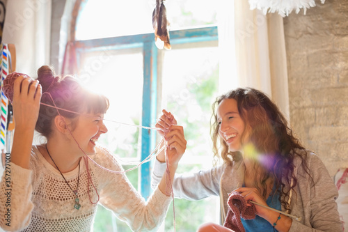 Women playing with yarn together photo