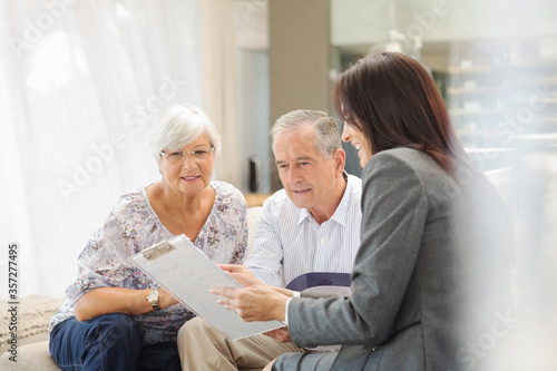 Financial advisor talking to couple on sofa