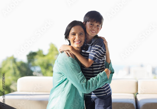 Mother and son hugging outdoors