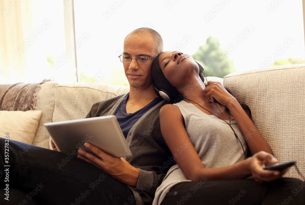 Fototapeta premium Couple relaxing together on sofa