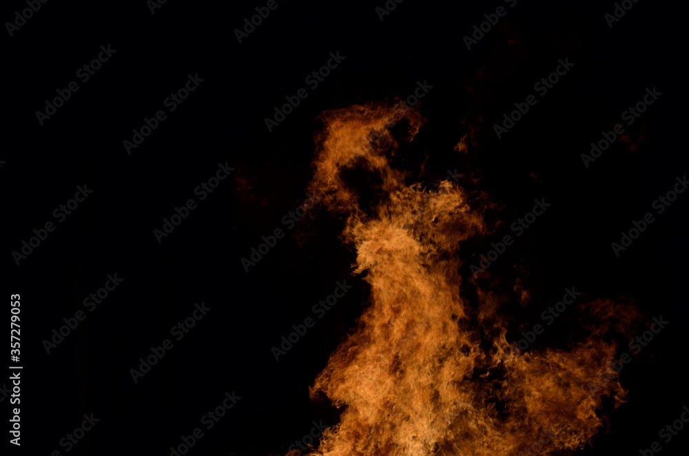 beautiful hot burning tall flames from bonfire on dark winter background beautiful hot burning tall flames from bonfire on dark winter background
