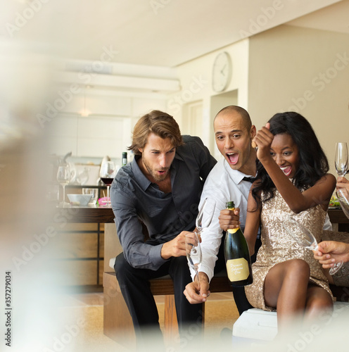 Quadro em tela Friends opening bottle of champagne together