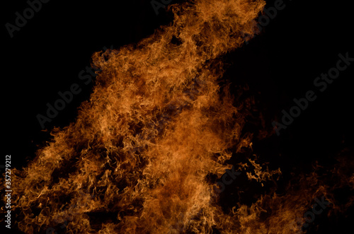 beautiful hot burning tall flames from bonfire on dark winter background