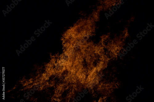 beautiful hot burning tall flames from bonfire on dark winter background