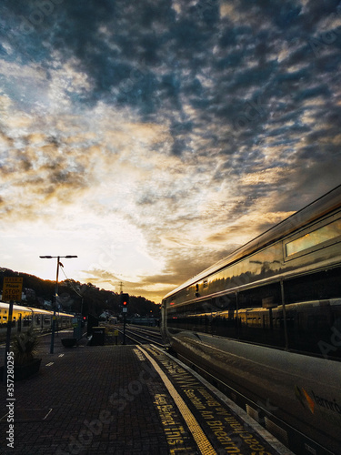 Train departing during sunrise