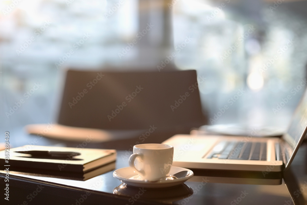 Coffee cup, laptop, notebook and pen in office Coffee cup, laptop, notebook and pen in office