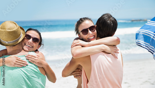 Happy couples hugging at beach