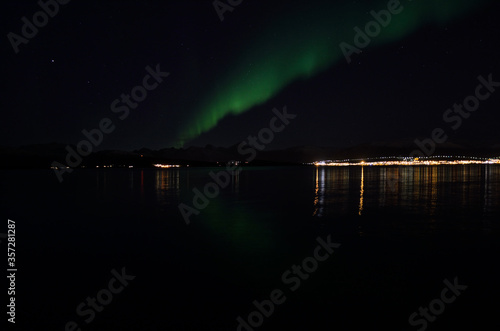 aurora borealis in autumn night with city light background