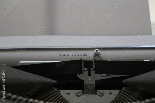close up of an old typewriter with a message of slow living