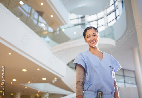 Portrait of smiling nurse in hospital atrium