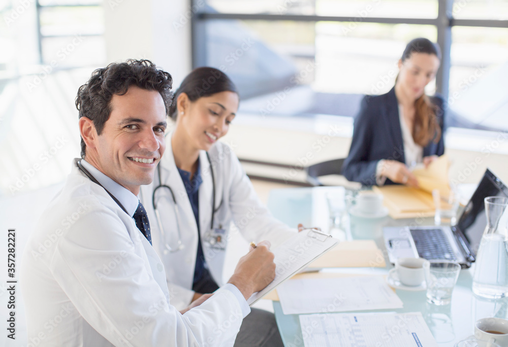 Portrait of smiling doctor in meeting Portrait of smiling doctor in meeting