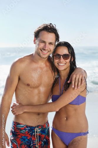 Portrait of smiling couple hugging on beach © Dan Dalton/KOTO