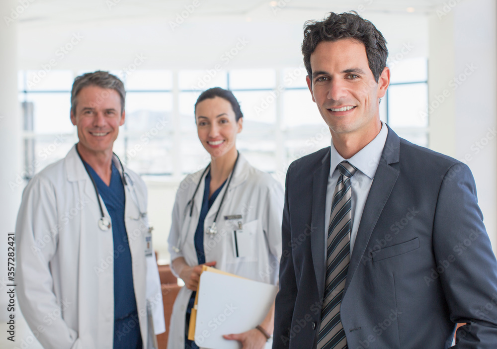 Obraz premium Portrait of confident businessman and doctors