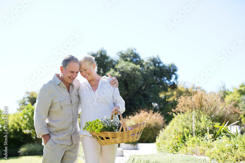 фотографія Senior couple walking with basket outdoors