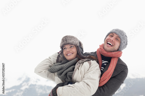 Happy couple hugging with mountain in background