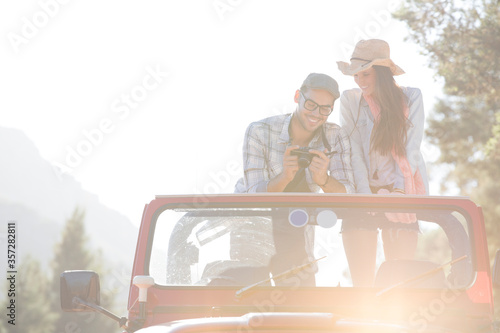 Couple with digital camera in sport utility vehicle