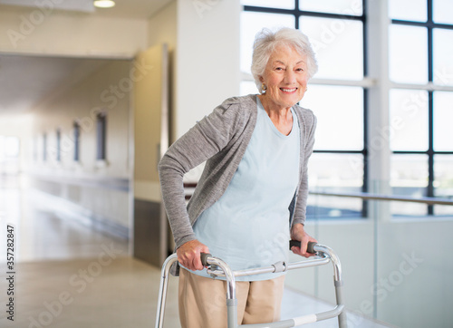 Senior patient using walker in hospital photo