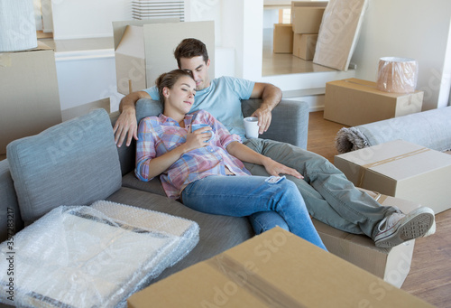 Couple relaxing on sofa in new house
