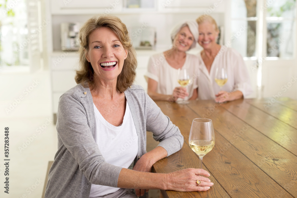 Portrait of smiling senior women drinking white wine Portrait of smiling senior women drinking white wine