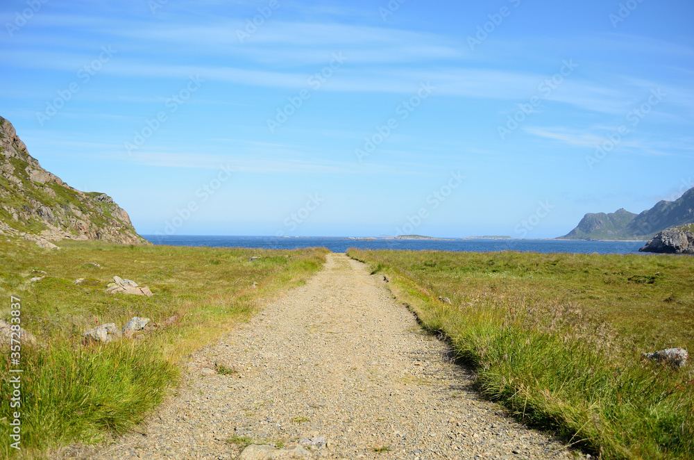 long dirt road down to blue ocean