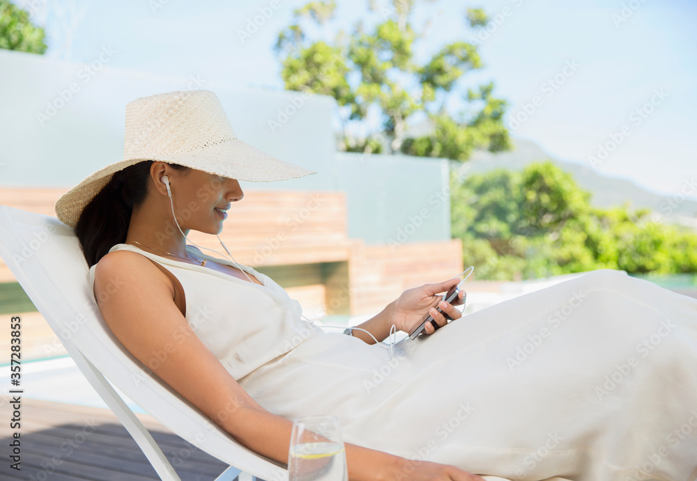 Woman listening to mp3 player outdoors