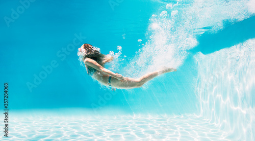 Fényképezés Woman swimming underwater in swimming pool