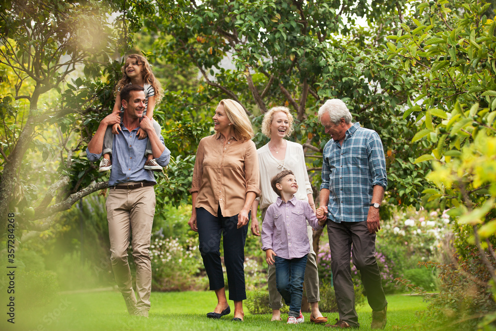 Multi-generation family walking together in park