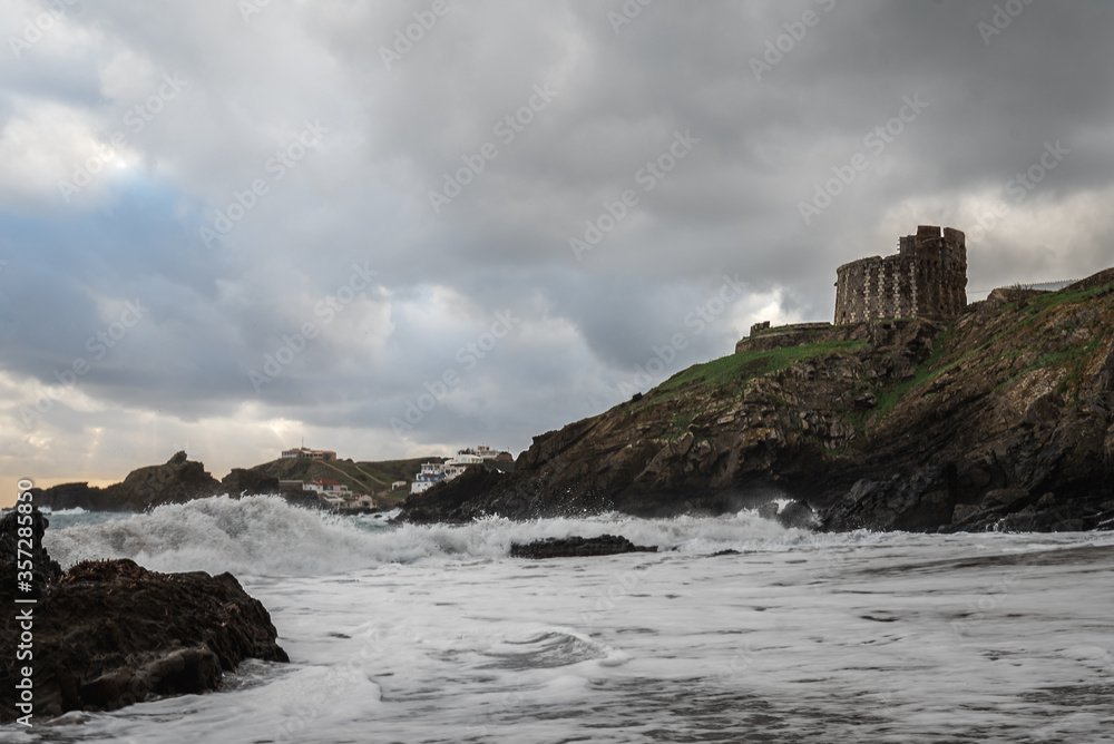 sa mesquida beach in a stormy day, and old british defense tower, abandoned paradise beach in Menorca, a Spanish Mediterranean island, after the covid 19 coronavirus crisis