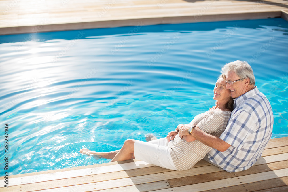 Senior couple relaxing by pool