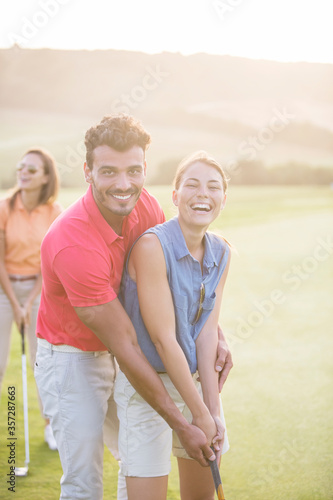 Couple playing golf on course