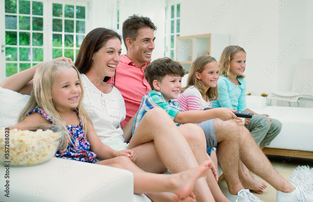 Family watching television together Family watching television together