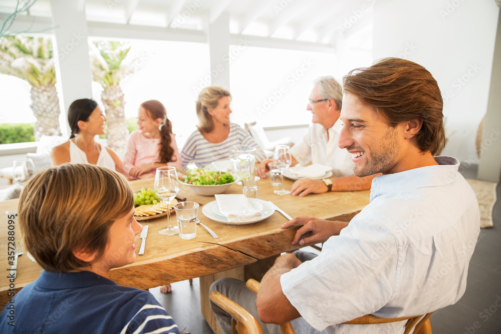 Multi-generation family eating together at table