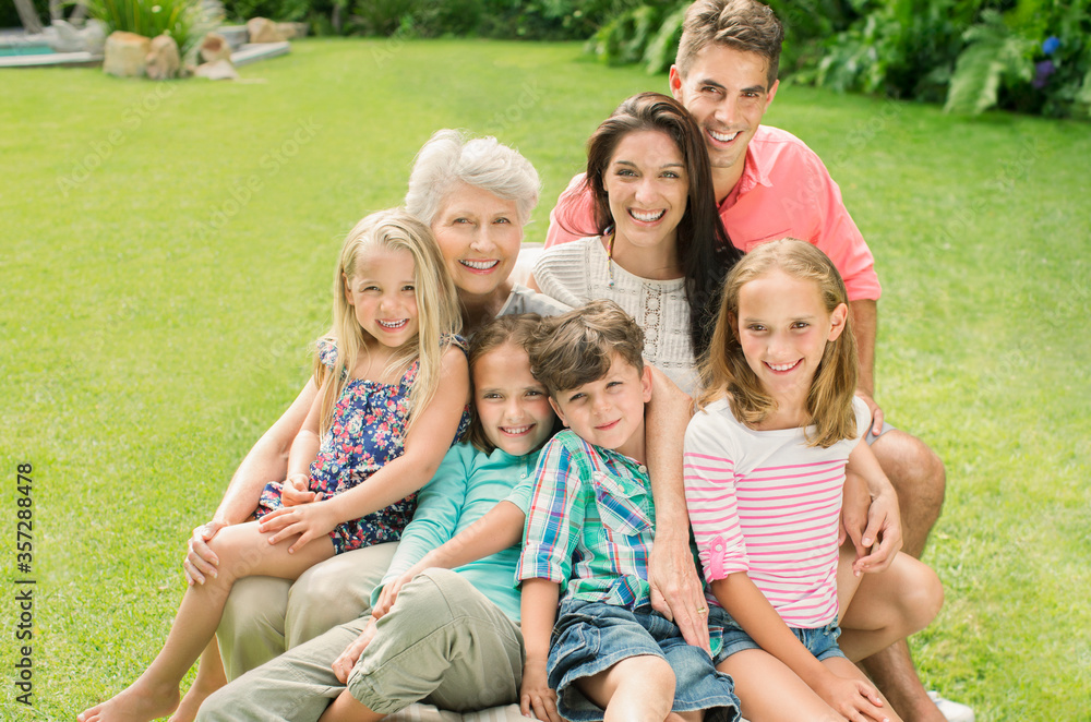 Multi-generation family smiling together in backyard