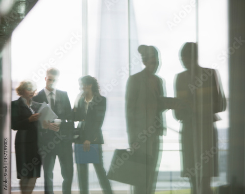 Photography Reflection of business people talking in office