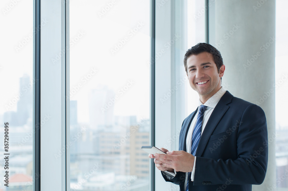 Businessman using cell phone in office Businessman using cell phone in office
