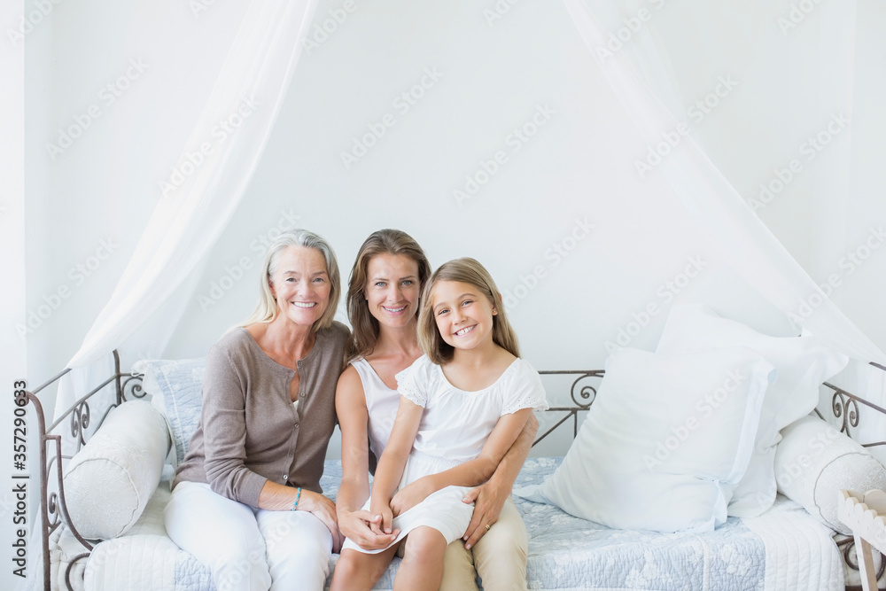 Multi-generation women smiling on daybed Multi-generation women smiling on daybed