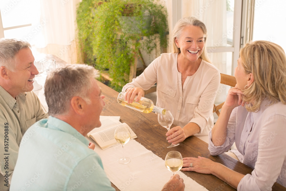 Senior couples drinking wine at dining table Senior couples drinking wine at dining table