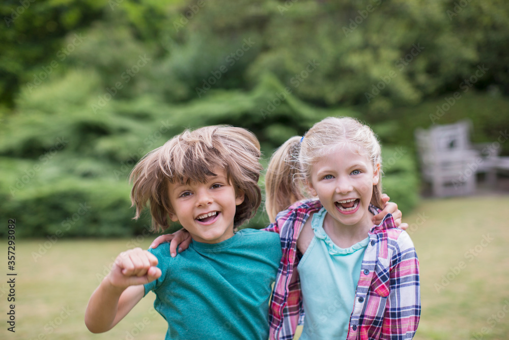 Fototapeta premium Smiling children hugging outdoors