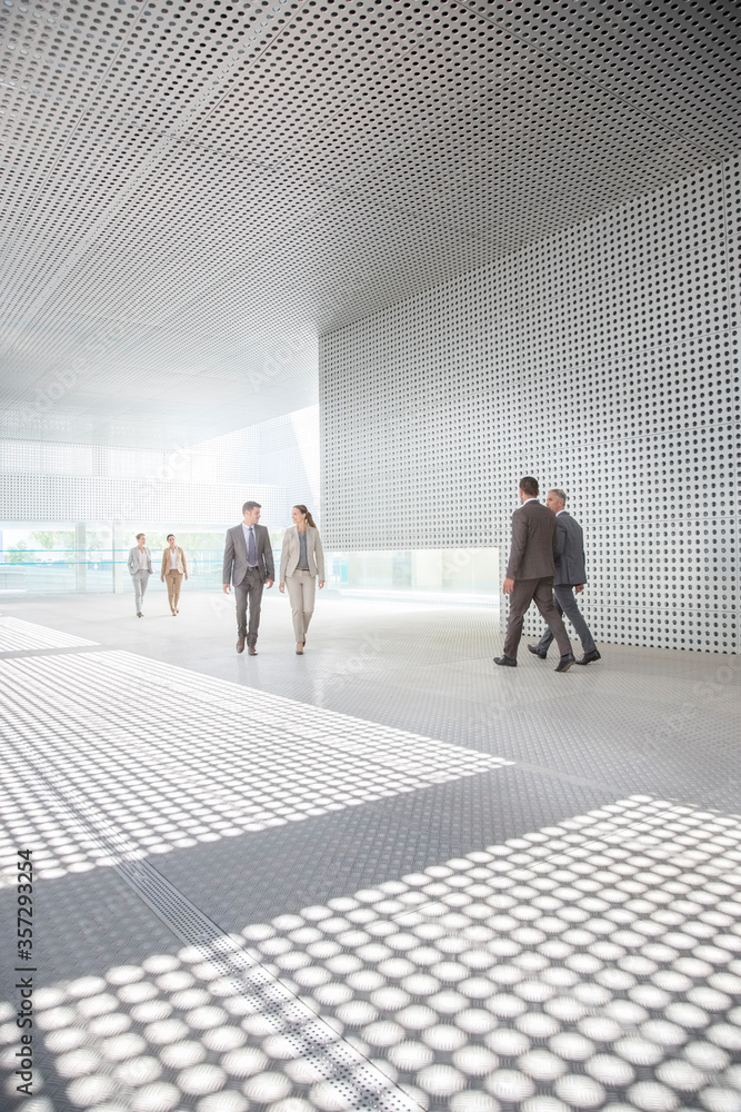 Business people walking outside modern building Business people walking outside modern building